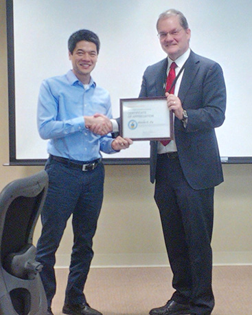 Dr. Kevin Fu receives a certificate for his service for ISPAB from Chuck Romine, NIST's ITL Director.